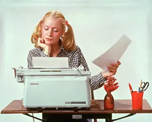 Oldtime Prints: 1970s YOUNG WOMAN BLONDE HAIR AT ELECTRIC HERMES TYPEWRITER THOUGHTFUL PENSIVE STUDENT TYPING WEARING HAIR IN PIGTAILS