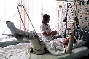 Archives Prints: 1976 - A nurse adjusts the intravenous feeding line on a patient