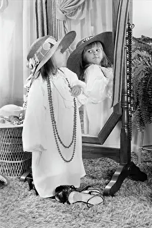 Oldtime Prints: 1980s LITTLE GIRL DRESSED UP IN ADULT CLOTHES POSING BEFORE MIRROR FUN PLAY ROLE PLAYING HAT BEAD NECKLACE