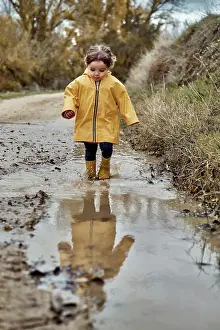 Runner Prints: A 2 year old girl playing with a mud puddle