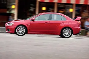 Blur Prints: 2009 Mitsubishi Lancer Evolution driving through city, side view