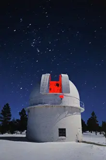 Stars Prints: The 42' telescope glows softly red in this time exposure of the dome illuminated by a partial moon