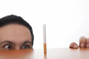 Smoking Prints: Addicted man voraciously looking at a cigarette