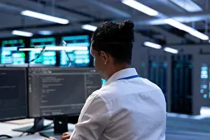 Electronics Prints: Admin in data center using diagnostic tools and system monitoring software on computer to identify root cause of errors