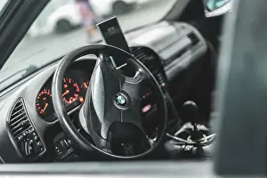 Features Prints: Adria, Italy 30 july 2024: Interior view of BMW E36 dashboard with steering wheel and illuminated gauges