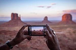 Pocket Prints: An adult male tourist takes a phone photo at Monument Valley, Arizona