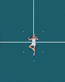Minimal Prints: Aerial drone view of a female tennis player laying on a blue tennis court in Melbourne