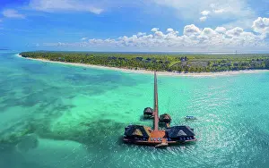 Body Of Water Prints: Aerial shot of the Stilt hut with palm thatch roof washed with t