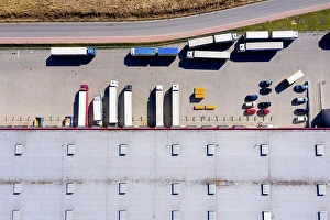 Heavy Prints: Aerial Shot of Truck with Attached Semi Trailer Leaving Industri