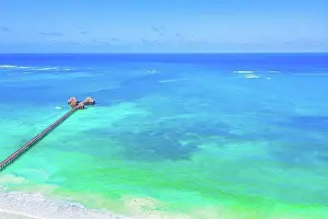 Luxury Prints: Aerial view of beautiful hotel in Indian ocean at sunset in summ