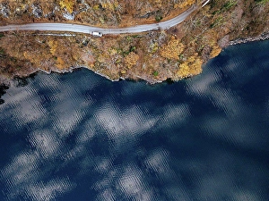 Georgia Prints: Aerial view of country road stretching along shore of Lake¶ÿRitsa¶ÿin autumn