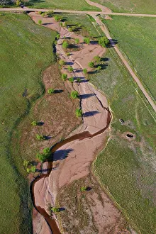 Prairie Prints: An aerial view of a creek striking through the plains of eastern Colorado