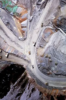 Truck Prints: Aerial view of dump trucks on the road leading to the Grasberg Mine on the Jayawijaya Mountains