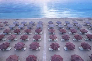 Aerial Prints: Aerial view of large group of tidy beach umbrellas facing the Mediterranean Sea