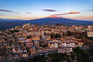 Architectural Prints: Aerial view of the old village of Centuripe with Mount Etna volcano covered with snow and lit by the sunset