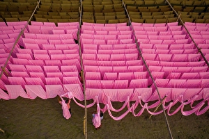 Forms Prints: Aerial view of a person working in a public laundry hanging for drying colourful cloth in Narayanganj
