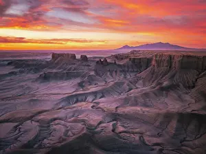Arid Prints: Aerial View of Rugged Desert Badlands at Sunrise with Vibrant Sky