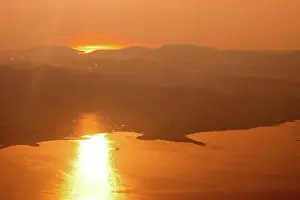 Evening Atmosphere Prints: Aerial view of sunset, sunrise over sea, coastline of Athens, Greece shot from airplane