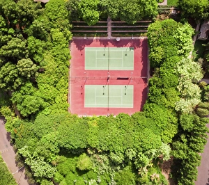 Aerial Prints: Aerial view of tennis courts in the middle of dense vegetation in Dubai, U.A.E