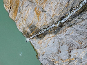 Outdoor Pursuit Prints: Aerial top down view of a zodiac with tourist viewing Misty Fjords waterfall in Misty Fjords National Monument