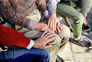 45 To 50 Years Prints: Affectionate boy and father touching hands of grandfather in backyard