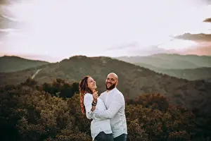 Cheerful Prints: Affectionate couple having fun on hilly valley