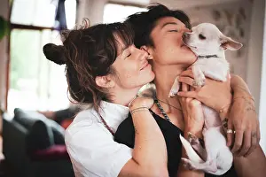 Kindness Prints: affectionate portrait of queer interracial family couple with dog