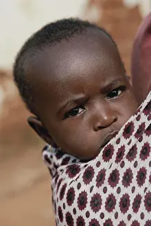 Staring Prints: Africa, East Africa, Tanzania. Rural western Tanzania. Baby boy