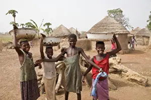 Muslim Prints: Africa, West Africa, Ghana, Yendi. Young Dagomba girls carrying pots