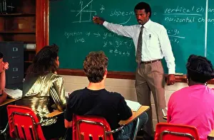 Students Prints: An African-American high school math teacher standing in front of a chalk board