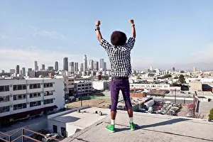 Chic Prints: African American man overlooking cityscape from urban rooftop