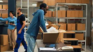 Organizing Prints: African american owner taking products from storage racks