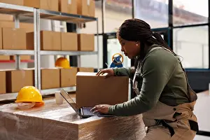 Logistics Prints: African american worker checking customers orders