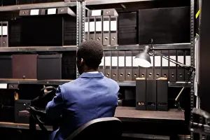 Analysis Prints: Agent checking surveillance evidence