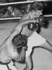 Indigenous Prints: Alf Sands lands a left to the chin in his points win over Al Bourke at the Stadium last night