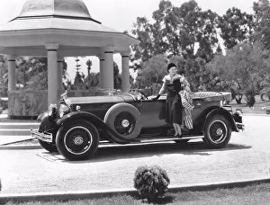 Luxury Prints: American car in the 1930s. A young Hollywood woman poses on the elegant new Packard car