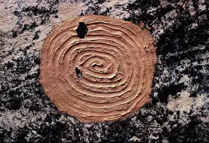 Anthropology Prints: Ancient Ancestral Pueblo mud spiral pictograph on black soot-covered wall of ruin