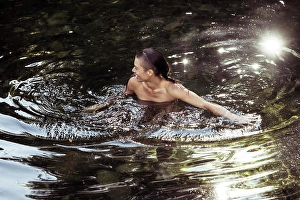 Kindness Prints: Androgynous young person wading in luscious water