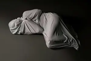 Anonymous Prints: Anonymous person wrapped in cloth lying on floor High angle full body of unrecognizable person wrapped in light gray