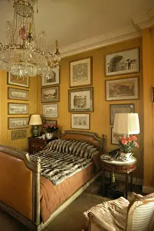 Bedrooms Prints: Antique glass chandelier above single bed with faux fur throw in bedroom with black