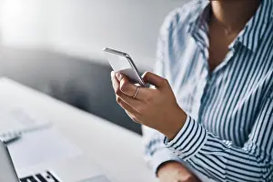 Typing Prints: App, business and phone in hand of woman at office for communication