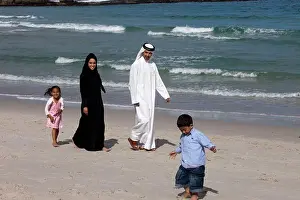 Two Parents Prints: Arab family at the beach, children running on the sand