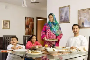 Male Adult Prints: Arab Family looking at camera while dining