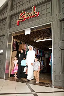 Father Prints: Arab family with shopping bag coming out of the middle eastern shop