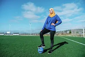 Activewear Prints: Arab female football player with ball on field