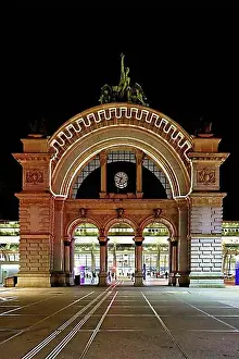 Entrances Prints: Archway on the station square, light installation at dusk