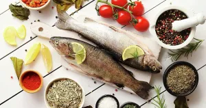 Assortment Prints: Aromatic spices and vegetables around fish From above shot of various aromatic spices