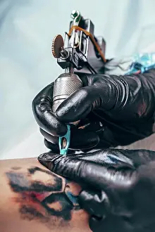 Toughness Prints: Artist tattooing design on human hand