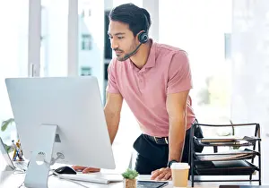 Decision Prints: Serious asian man, call center and computer in customer service or desktop support at office desk