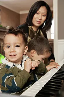 Instrument Prints: Asian mother teaching sons to play piano